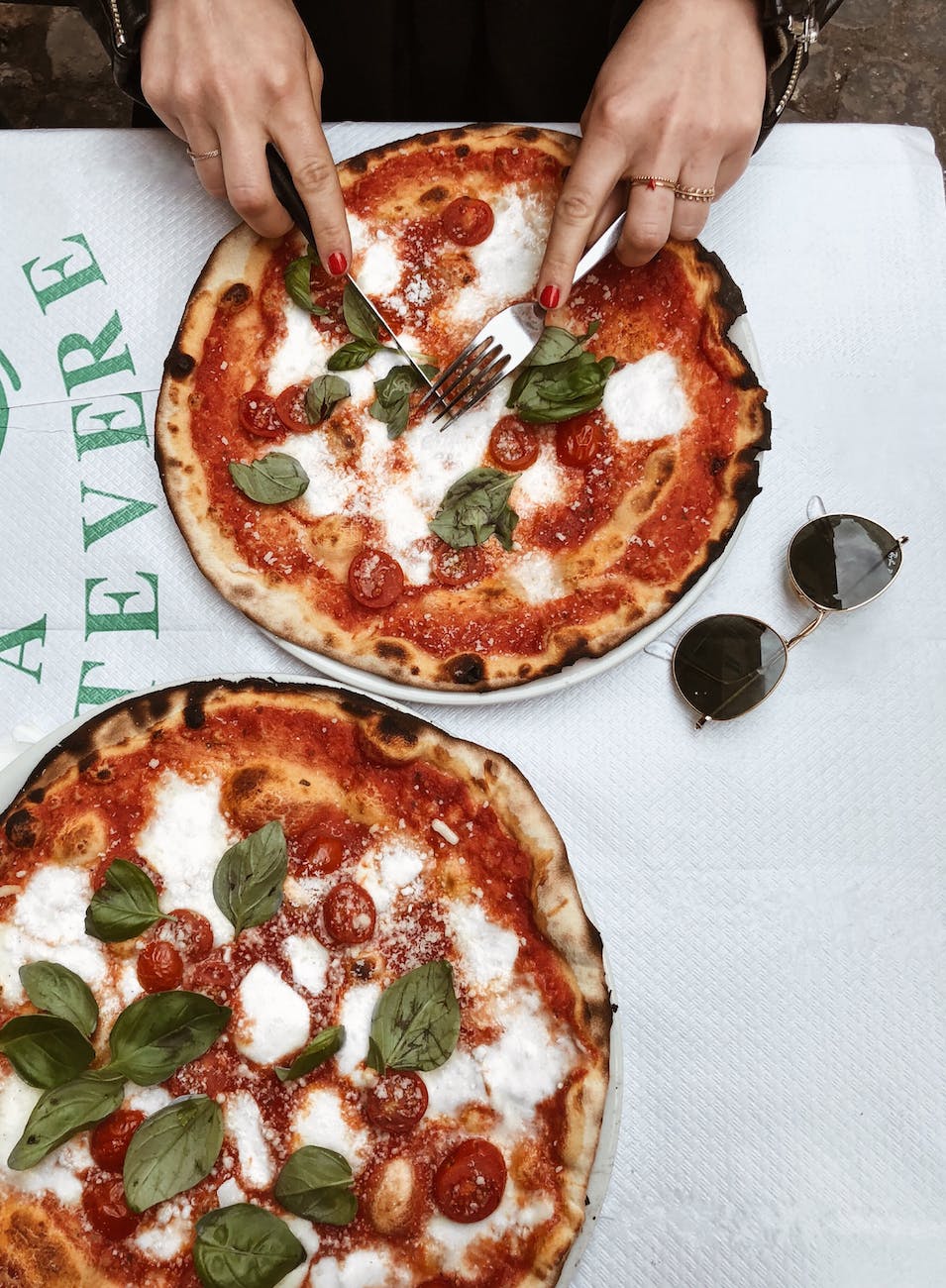 A delicious pizza Margherita, freshly baked to perfection, with a mouthwatering blend of vibrant tomato sauce, creamy mozzarella cheese, and aromatic basil leaves, embodying the essence of Italian culinary artistry.